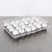 A Polar Pak clear plastic container holding cupcakes with white frosting and colorful beads.