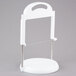 A white plastic stand with a silver metal saw on a white circular base.