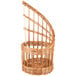 A close-up of a Matfer Bourgeat round wicker bread basket with a curved top and a handle.