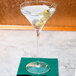 A Spiegelau Willsberger martini glass with olives on top.