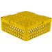 A yellow plastic Vollrath Traex dish rack with extenders and holes.