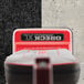 A red and grey Oreck upright vacuum cleaner with a white logo.