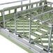 A Vollrath light green metal rack with metal bars.