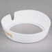 A white circular Tablecraft salad dressing dispenser collar with beige lettering.