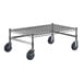A chrome plated metal Regency dunnage rack with black wheels.
