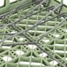 A light green Vollrath dish rack with metal rods.
