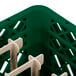 A close up of a green Vollrath Traex peg rack with plastic holders.