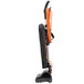 A black and orange Hoover Task Vac commercial bagged vacuum cleaner with a handle.