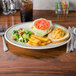 A Homer Laughlin green banded oval platter with food on a table.