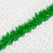 A Scrubble 19" carpet bonnet with green scrubber strips on a white knitted surface.