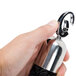 a hand holding a silver bell