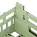 A light green plastic Vollrath dish rack with metal handles.
