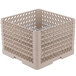 A beige plastic Vollrath Traex plate rack with many holes.