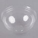A clear plastic bowl with a clear plastic dome lid on it.