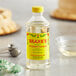 A close-up of a bottle of Shank's Pure Spearmint Extract on a table.