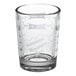 A clear Libbey measuring glass with white text.