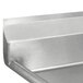 A close-up of an Advance Tabco fabricated three compartment pot sink with two drainboards.
