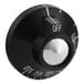 A black Garland dial control knob with white text and a white button on it.