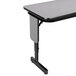 A grey rectangular Correll seminar table with black panel legs.