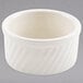 A white Hall China souffle dish with a wavy pattern.