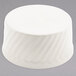 A white round Hall China souffle dish with a wavy pattern.