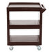 A dark brown Cambro three shelf service cart with wheels.