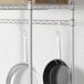 A Regency chrome hanger rail holding pans and pots.