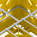 A yellow Vollrath Traex Plate Crate with white rods.