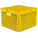 A yellow plastic Vollrath Traex plate rack with holes.