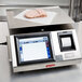 A Tor Rey WiFi thermal label printing scale on a counter with a piece of meat on it.
