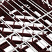 A close up of a metal grid with a red and white pattern on a white background.