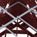 A red Vollrath Plate Crate with metal bars.