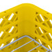 A yellow plastic Vollrath Traex plate rack with metal rods.