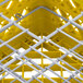 A yellow Vollrath Traex plate rack with wire compartments.