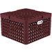 A burgundy plastic Vollrath Traex plate rack with 21 compartments and a white label.