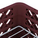 A burgundy Vollrath Traex plate rack with metal handles.
