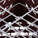 A close up of a metal Vollrath Plate Crate with wires.