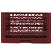 A red plastic Vollrath Traex plate rack with 12 compartments.