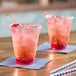 Two Choice clear plastic cups with drinks and straws on a table.