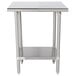 An Advance Tabco stainless steel work table with a shelf.