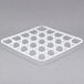 A white plastic grid with holes.