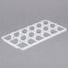 A white plastic grid with rows of hexagons.