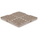 A beige Vollrath TR13 plastic grid with holes.