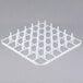 A white plastic grid with many square holes.
