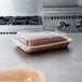 A brownie in a Solut paperboard container on a counter.