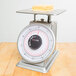 A Taylor heavy duty mechanical portion scale on a counter.