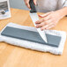 A person sharpening a knife on a Victorinox Crystolon stone.