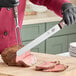 A person cutting meat with a Victorinox knife and fork.