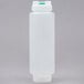 A white plastic bottle with a green cap.