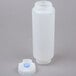 A white plastic bottle with a blue cap with a thick valve.